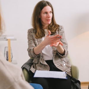Addiction coach guiding a client through recovery planning session